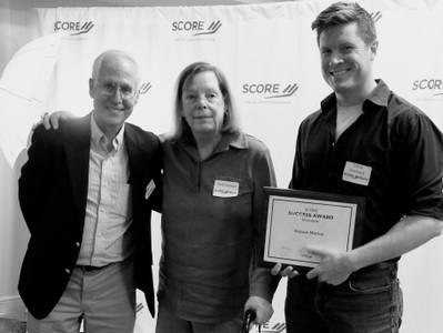Toby Dewhurst, Kelson's CEO, accepting the 2023 SCORE Award for Best Innovative Small Business