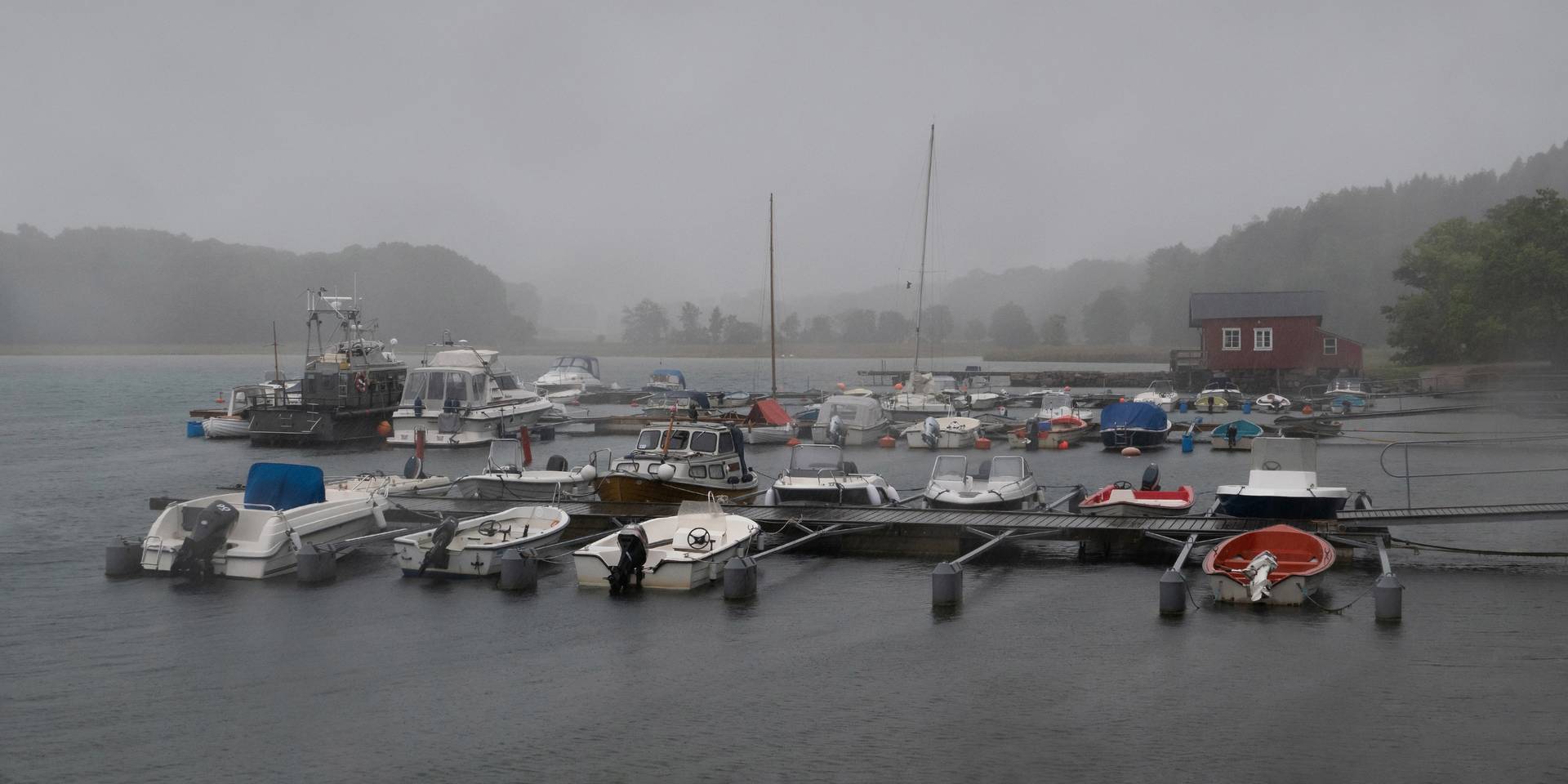 Marina with floating docks and rainy, foggy weather